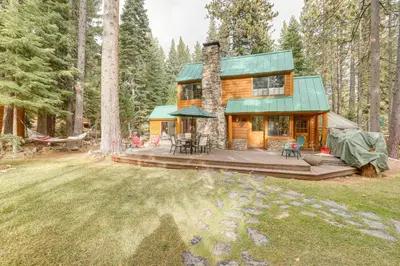 a log cabin in the woods with a deck at Less Than 1 Mi to Lake Tahoe Beaches Home with Fire Pit! in Tahoe City