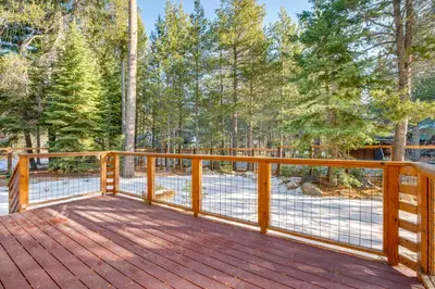 a wooden deck with a fence and trees at Less Than 1 Mi to Beach Peaceful Studio with Deck in Tahoma in Tahoma