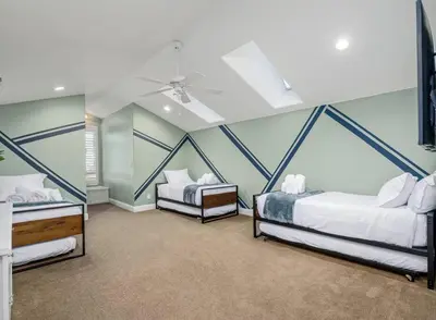 two beds in a room with blue walls at Luxury 4 Acre Estate - Pickleball, Pool, Hot Tub! in Lockeford