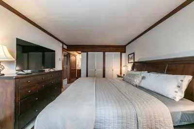 a bedroom with a large bed and a flat screen tv at 4BD Lakeside Retreat with Views in Tahoe City