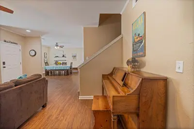 a living room with a couch and a staircase at Yosemite Bass Lake Adventure Oasis in Bass Lake