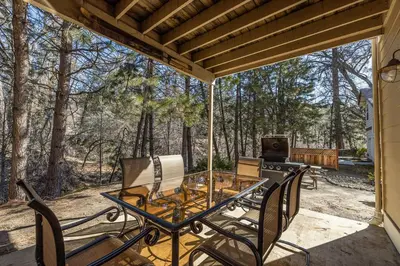 a patio with a table and chairs and a grill at Yosemite Bass Lake Adventure Oasis in Bass Lake