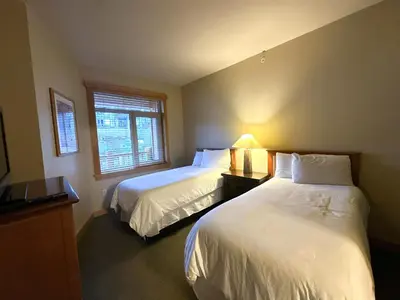 a bedroom with two beds and a lamp on a table at Ski-in/Ski-out with views at Sunstone in Mammoth Lakes