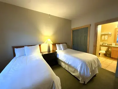 a hotel room with two beds and a bathroom at Ski-in/Ski-out with views at Sunstone in Mammoth Lakes