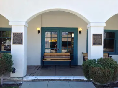 a building with a blue door with a bench outside at Historic Dow Hotel in Lone Pine