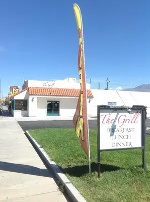 a sign with a flag next to a building at Historic Dow Hotel in Lone Pine