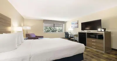 a hotel room with a bed and a flat screen tv at Best Western Amador Inn in Jackson