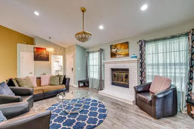 a living room with a couch and a fireplace at Cozy Antelope Home about 14 Mi to Sacramento! in Antelope