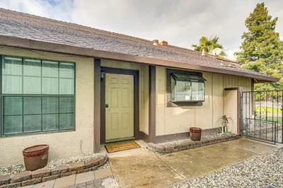 a house with a green door and a fence at Cozy Antelope Home about 14 Mi to Sacramento! in Antelope