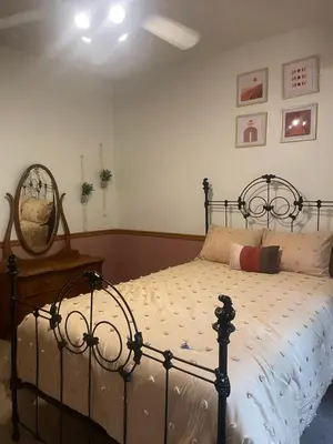 a bedroom with a bed and a mirror on the wall at RiverFront Retreat- Spa/Hot tub, Game Room, Limited Gym in Three Rivers