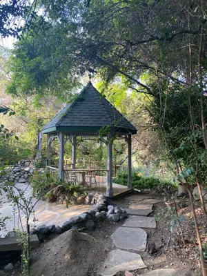 a gazebo in the middle of a garden at RiverFront Retreat- Spa/Hot tub, Game Room, Limited Gym in Three Rivers