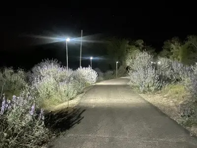 a dirt road at night with street lights at RiverFront Retreat- Spa/Hot tub, Game Room, Limited Gym in Three Rivers