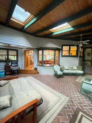 a bedroom with a large bed and a living room at RiverFront Retreat- Spa/Hot tub, Game Room, Limited Gym in Three Rivers