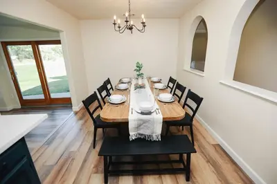 a dining room with a long table and chairs at Riverfront Beauty with Pickle Ball Court in Kingsburg
