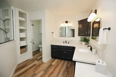 a white bathroom with a sink and a mirror at Riverfront Beauty with Pickle Ball Court in Kingsburg