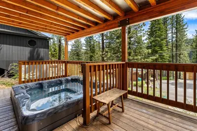 a hot tub on the deck of a house at Trailblazer Chalet at Olympic Valley with Private Hot Tub and Ski Shuttle in Alpine Meadows