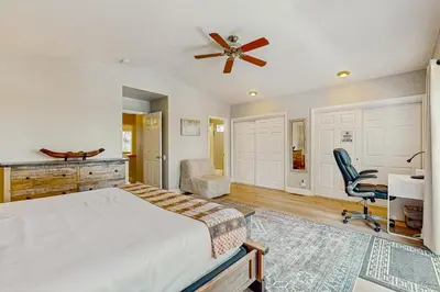 a bedroom with a bed and a desk and a chair at A Taste of Tahoe in Tahoe Vista