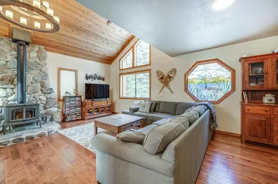 a living room with a couch and a fireplace at Family Cabin with Community Perks in Truckee! in Truckee