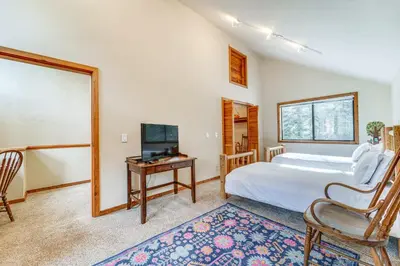 a bedroom with a bed and a desk with a television at Family Cabin with Community Perks in Truckee! in Truckee