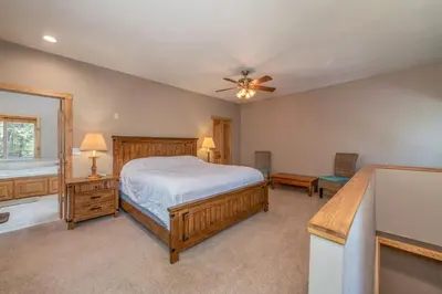 a bedroom with a bed and a ceiling fan at Peaceful Pinecone in Dorrington