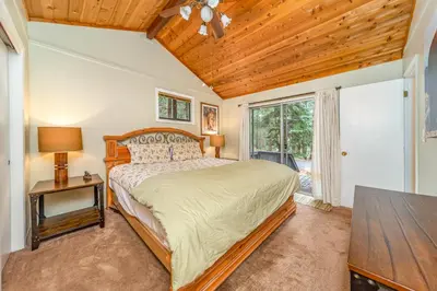 a bedroom with a bed and a wooden ceiling at Oso Borracho in Arnold