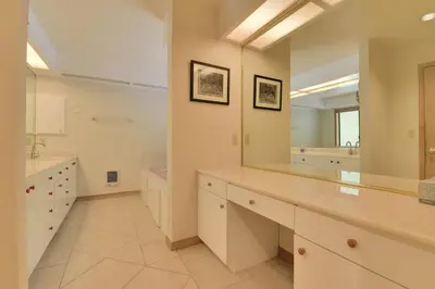 a large bathroom with white cabinets and a large mirror at Murphys View in Murphys