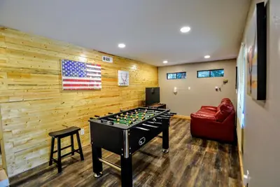 a room with a foosball table and an american flag at Grey Wolf Manor in Arnold