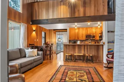 a living room with a couch and a kitchen at 3BD Three Minutes from King Beach in Kings Beach