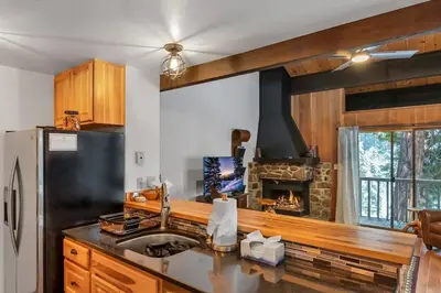 a kitchen with a sink and a fireplace at 3BD Three Minutes from King Beach in Kings Beach