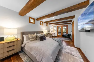 a bedroom with a large bed and a desk at Hideaway in the Highlands - 4BR, Pet Friendly w Hot Tub - Minutes from the Lake & Tahoe City in Tahoe City