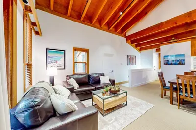a living room with a leather couch and a table at Northstar Nirvana in Truckee