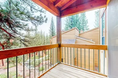 a balcony with a view of a house at Northstar Nirvana in Truckee