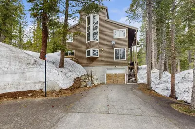 a house in the woods with a driveway at The Mountain House in Soda Springs