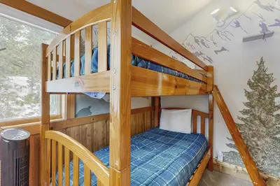 a bedroom with bunk beds in a house at The Mountain House in Soda Springs