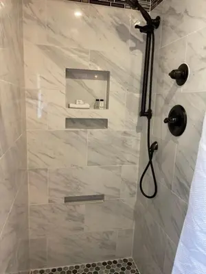 a shower in a bathroom with a glass door at Sugarloaf Mountain Motel in Virginia City