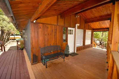a wooden porch with a bench on a deck at Bear Paw- Lake Area Winter Special Ends 51526 in Bass Lake