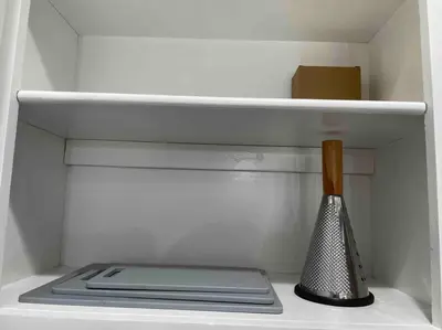 a white refrigerator with a utensil in it at Entire Modern House with King bed & 65inTV in Carmichael