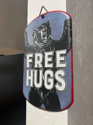 a free hugs sign on a wall at Modern Cabin, Near Snow Park, 3.5 Miles to SNP! in Three Rivers