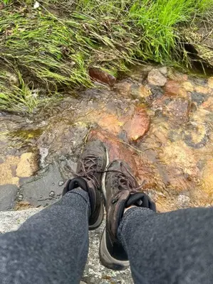 a person standing on a rock with their shoes at Modern Cabin, Near Snow Park, 3.5 Miles to SNP! in Three Rivers