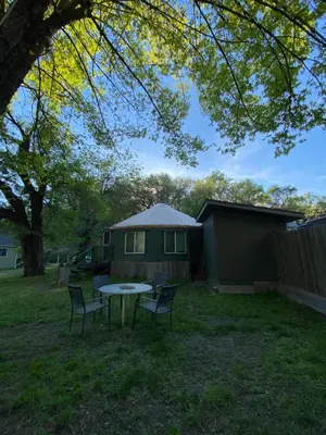 a backyard with a table and chairs and a house at Seven Circles Lodge&Retreat in Badger