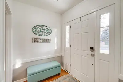 a white hallway with a door and a blue stool at Less Than 1 Mi to Midtown Pet-Friendly Home in Reno! in Reno