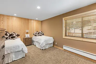 a bedroom with two beds and a window at Rocky Point # 14 Palisades Townhome - Ski Shuttle w Tennis! in Olympic Valley
