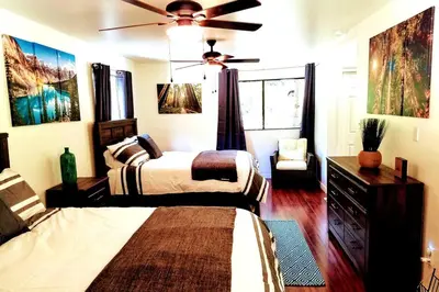 a bedroom with two beds and a ceiling fan at River Retreat Cabin in Three Rivers - near SNP in Three Rivers