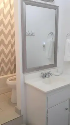 a bathroom with a sink and a mirror and a toilet at River Retreat Cabin in Three Rivers - near SNP in Three Rivers
