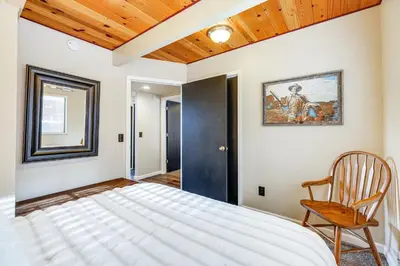 a bedroom with a bed and a wooden ceiling at Serene Cabin Retreat Between Murphys and Arnold in Murphys
