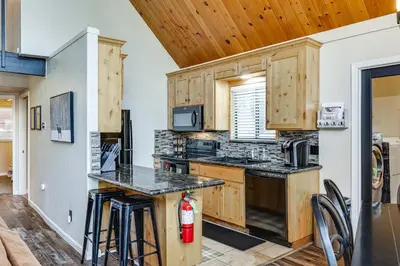 a kitchen with wooden cabinets and a stove at Serene Cabin Retreat Between Murphys and Arnold in Murphys