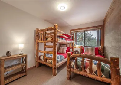 a bedroom with two bunk beds and a window at Northstar Resort Condo for 8 Free Shuttle in Truckee