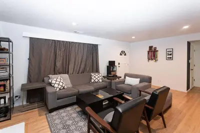 a living room with a couch and a table at SunHouse 1410sqft BBQ 3xTVs Pets W/D Backyard in Sacramento