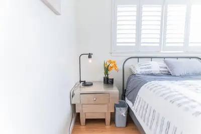 a bedroom with a bed and a table with a lamp at Arden Family Home BBQ Big Kitchen Backyard Pet W/D in Sacramento