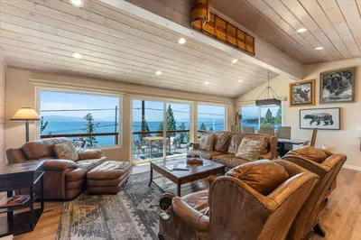 a living room with leather furniture and a large window at Big Blue Views Walk 2 Lake in Tahoe Vista